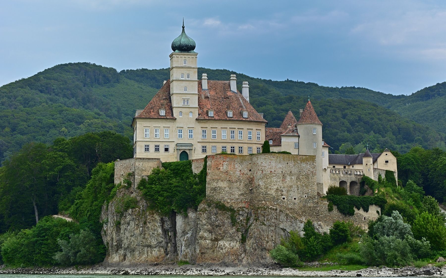 Linna korkealla kalliolla Tonavan rannalla.